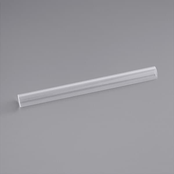 A clear plastic tube on a gray surface.