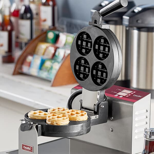 Estella mini Belgian waffles being made by a machine with a Estella Mini Belgian Waffle Plate inside.
