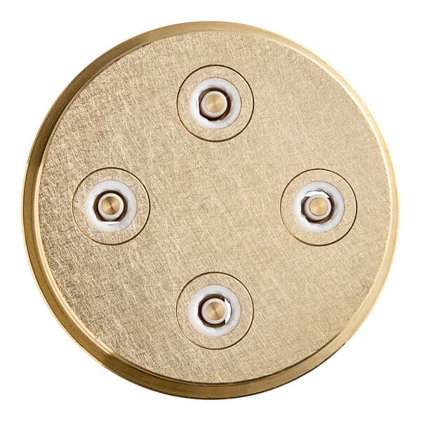 A circular gold pasta die with four holes.