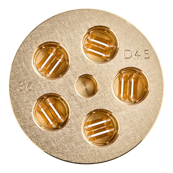 A circular gold pasta die with holes in it.