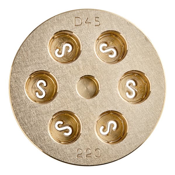 A circular brass Casarecce pasta die with holes in it.