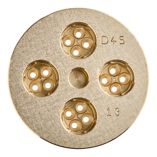 A circular brass Estella Bigoli pasta die with holes in it.
