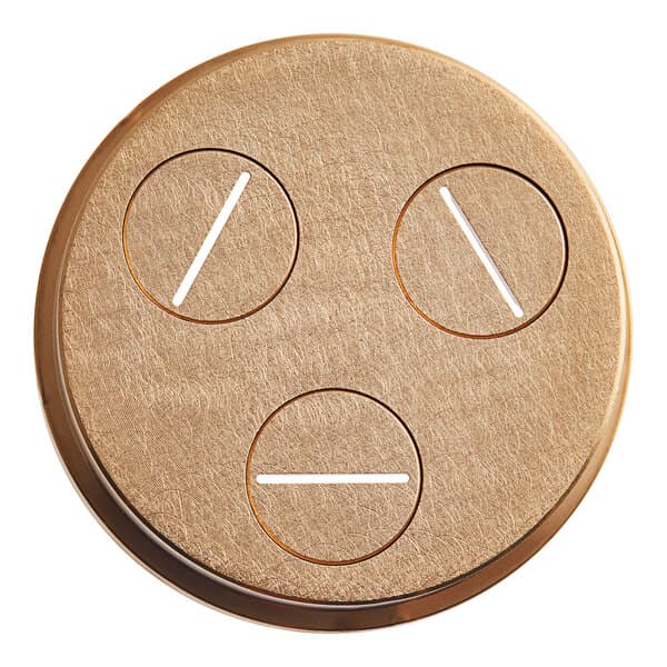 A circular brass object with circles and holes in it.