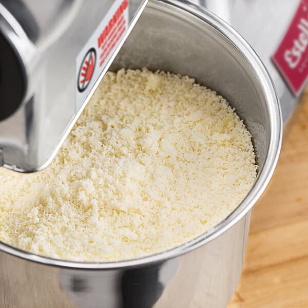 An Estella electric hard cheese grater with white cheese inside.