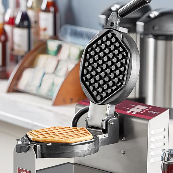 A hexagon shaped waffle on a white plate.