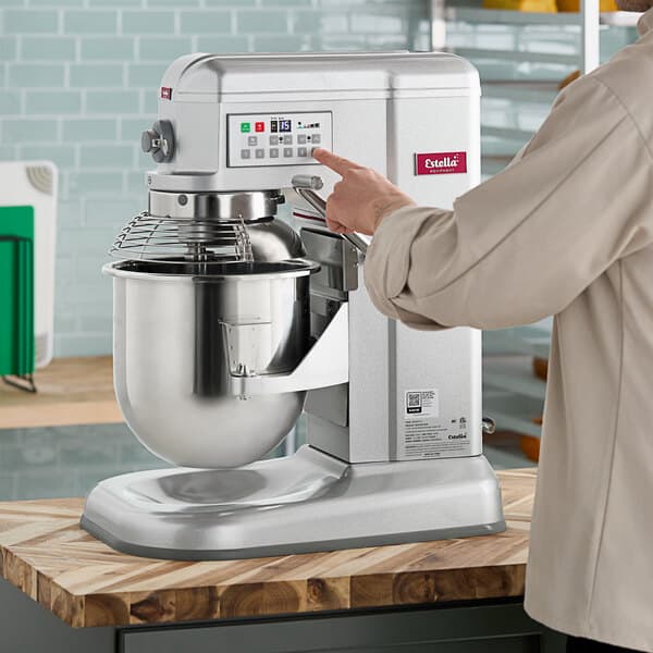 A person using a Estella countertop mixer.
