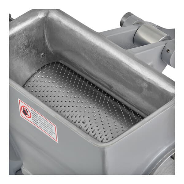 A metal Estella electric hard cheese grater inside a metal container with a mesh basket.
