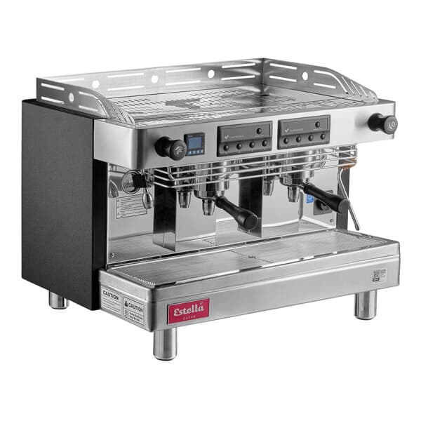 A silver and black Estella Caffe Two Group Teapresso Machine on a counter with three black handles.