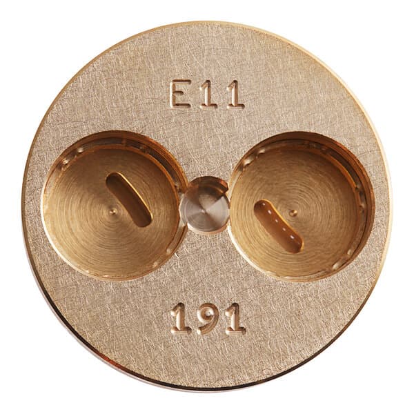 A circular object with numbers and a hole in the middle with a gold button.