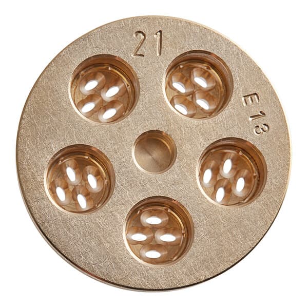 A circular brass pasta die with holes in it.