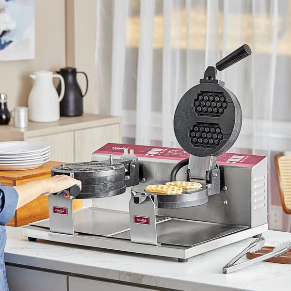 A woman using the Estella Double Belgian Waffle Maker to make waffles.