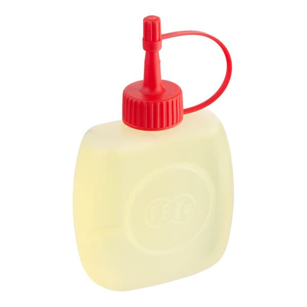 A small plastic bottle of Estella lubricating oil with a red nozzle cap.